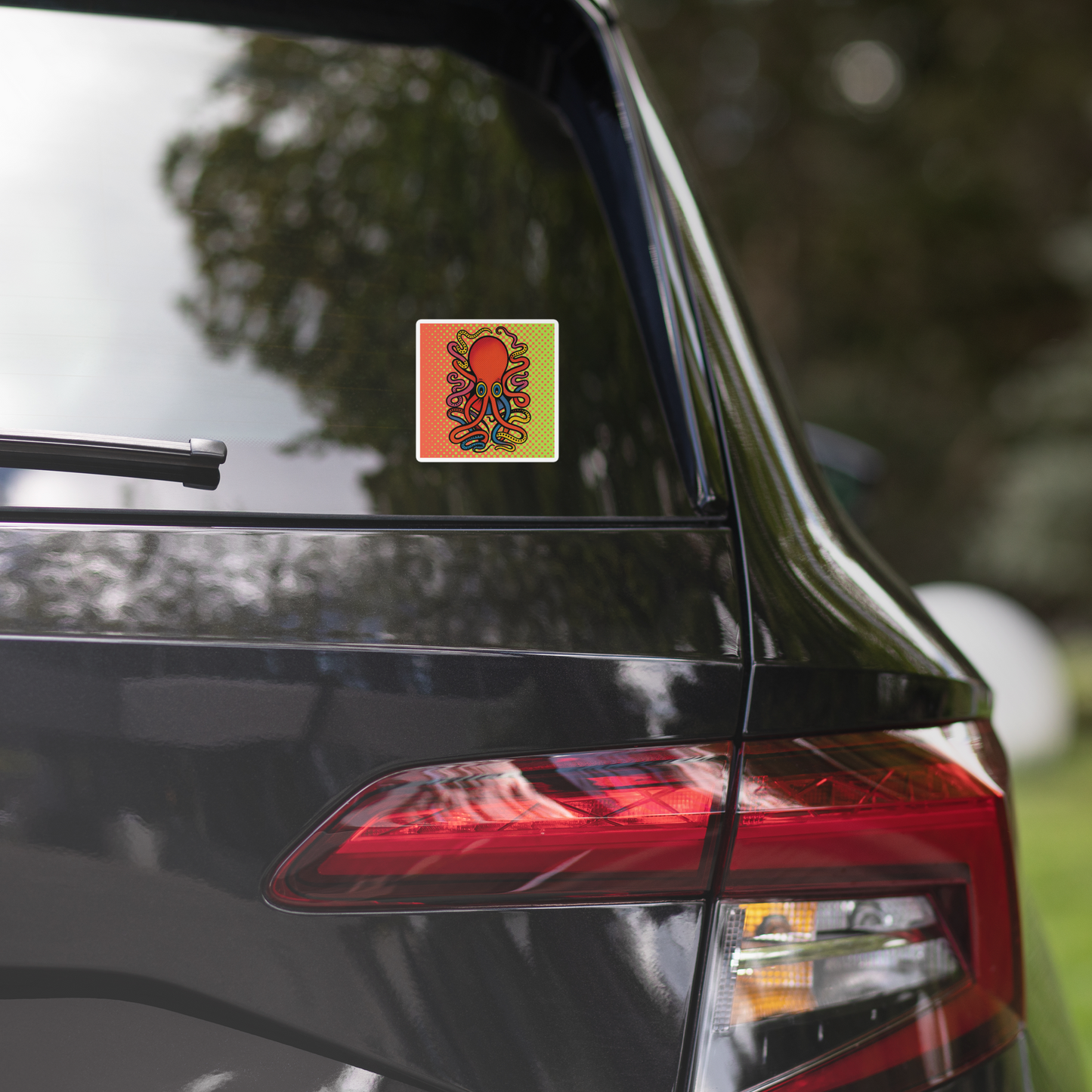 Car's rear view with 8 Armed Cuttlefish pop art vinyl sticker 4x4 — red, blue, and orange cuttlefish on halftone background