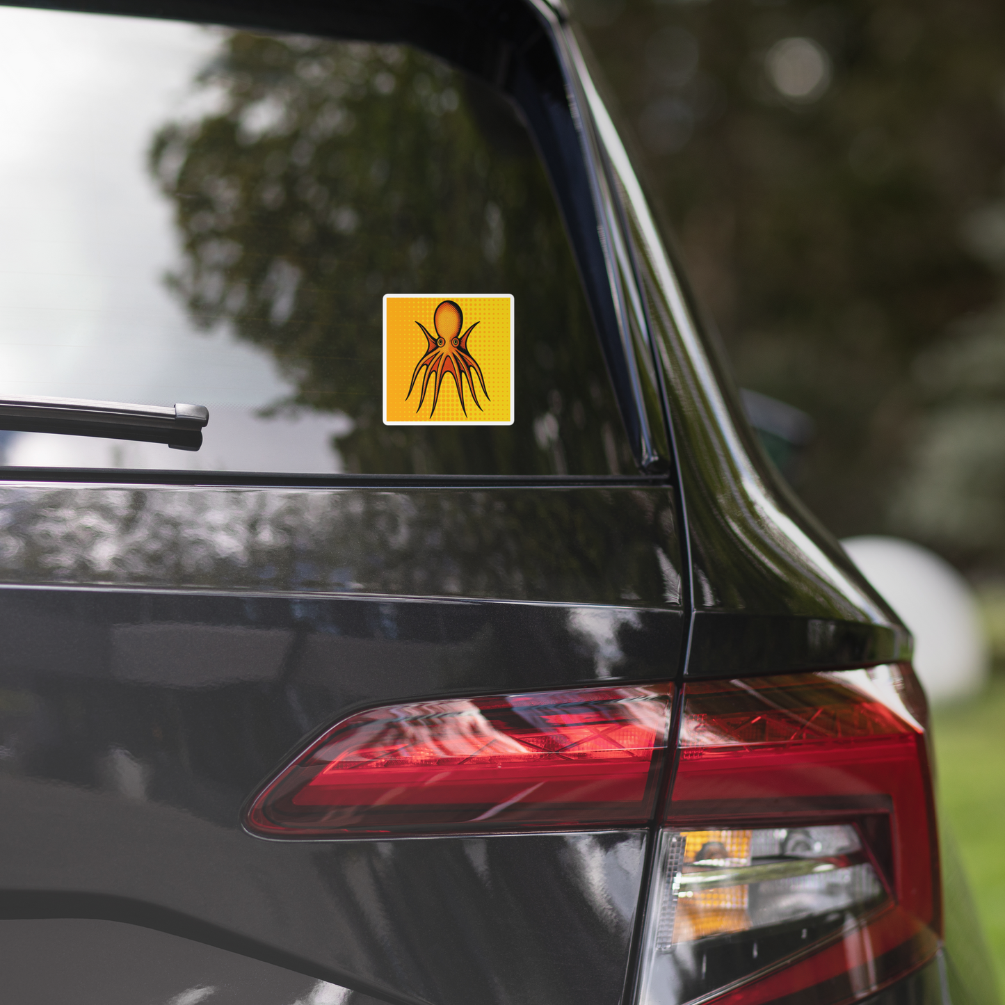 Car with Four Horn Tetracirrhus Octopus pop art vinyl sticker 4x4 — orange octopus with four horns on a yellow background on the back window