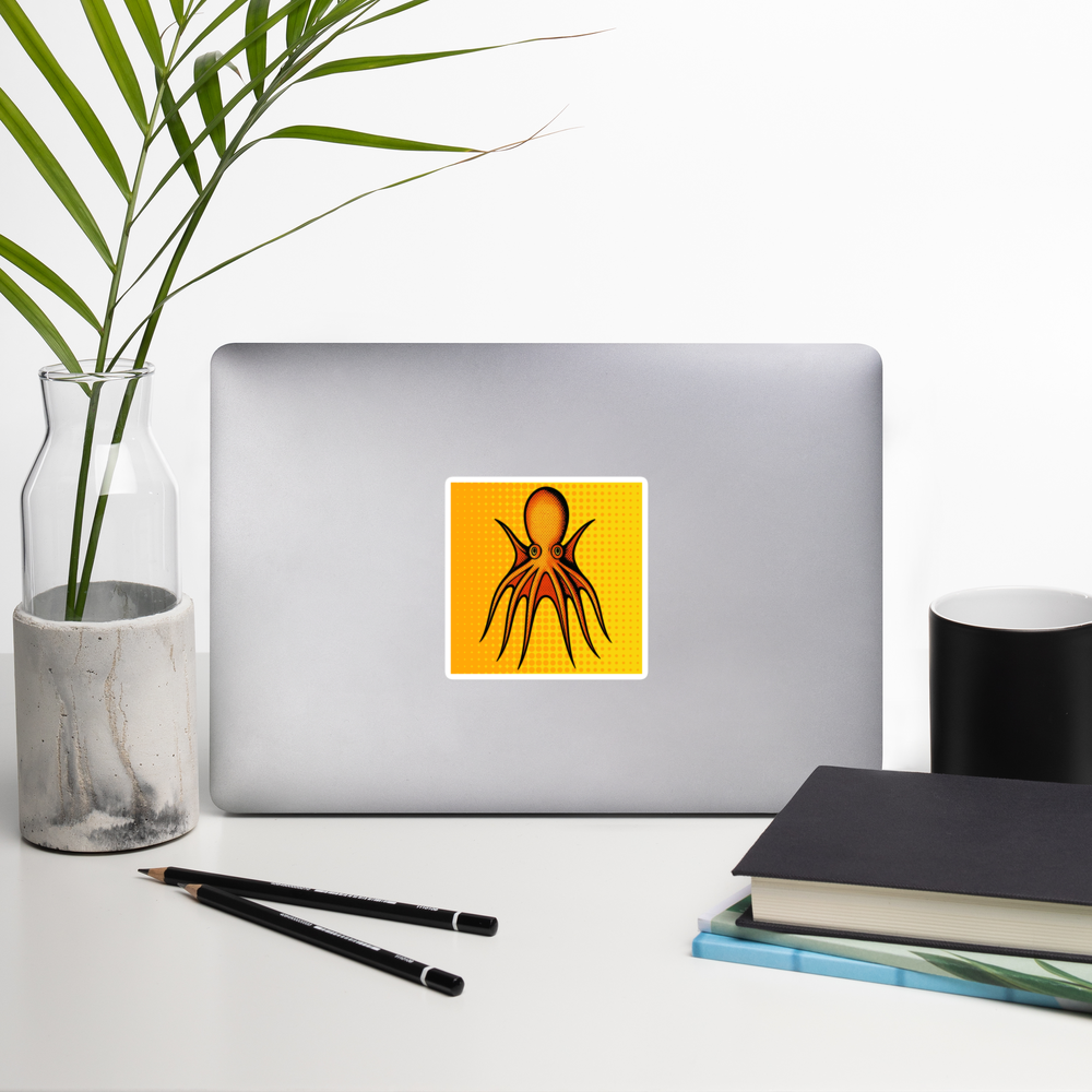Laptop with Four Horn Tetracirrhus Octopus pop art vinyl sticker 4x4 — orange octopus with four horns on a yellow background on a white surface with a plant and books.