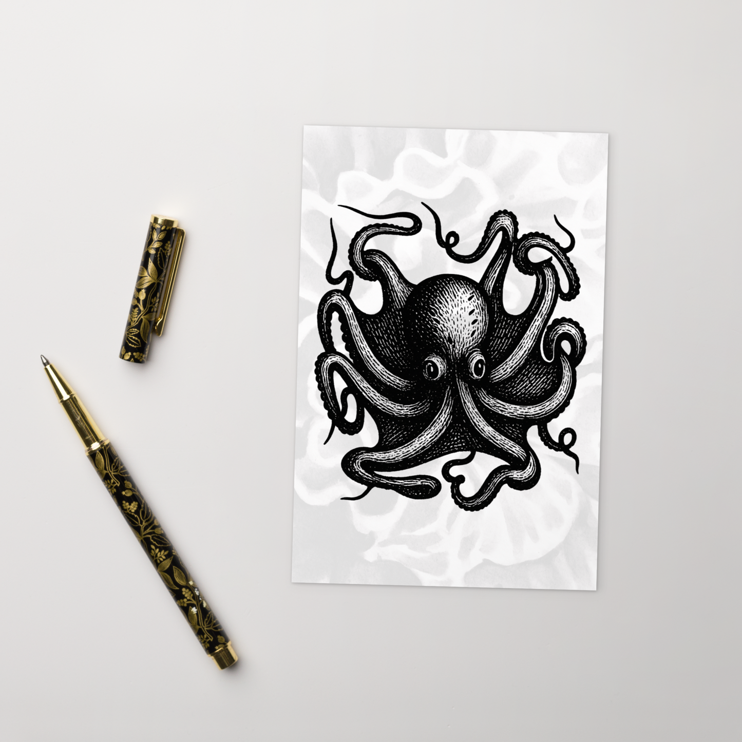 Octopus Vulgaris lithocut postcard — black and white illustration of common octopus with radiating arms with a decorative pen on a light gray background