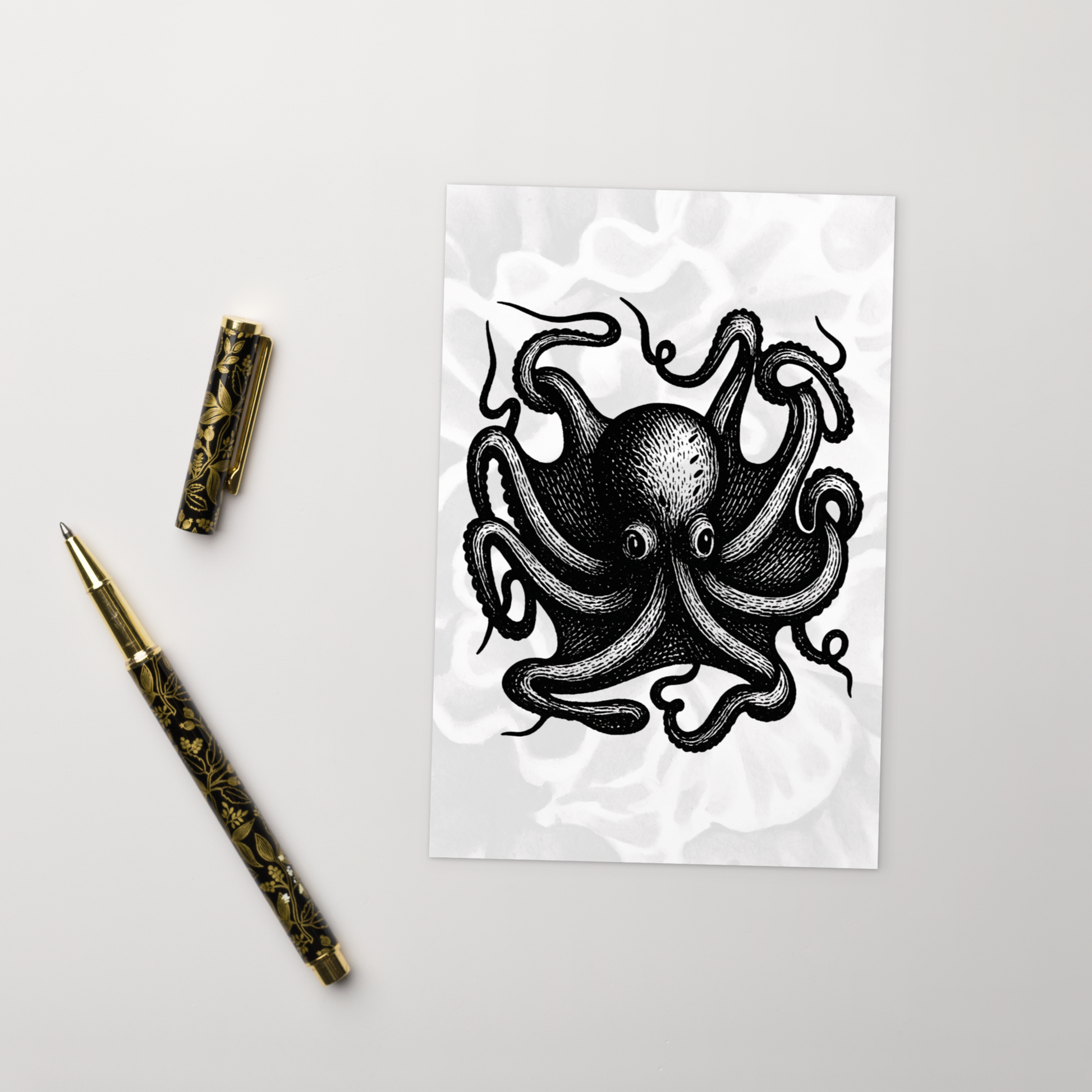 Octopus Vulgaris lithocut postcard — black and white illustration of common octopus with radiating arms with a decorative pen on a light gray background